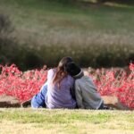 A mother sits with her children, embracing them on a hillside in Oklahoma City.