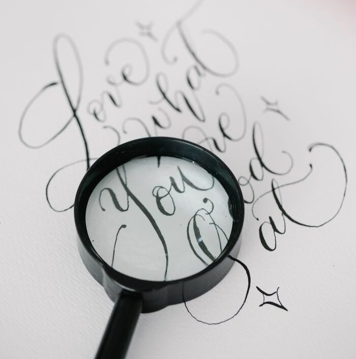 Beautiful calligraphy captured with a magnifier, highlighting art and design elements.